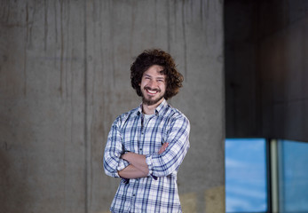 portrait of casual businessman in front of a concrete wall