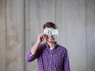 business man holding american dollars banknote over the eyes