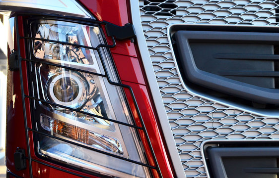 Frontal lighting products for on-highway vehicles, which includes integrated daytime running lights and beam patterns. Bi-Xenon and halogen headlamp of a modern truck, background texture - Image