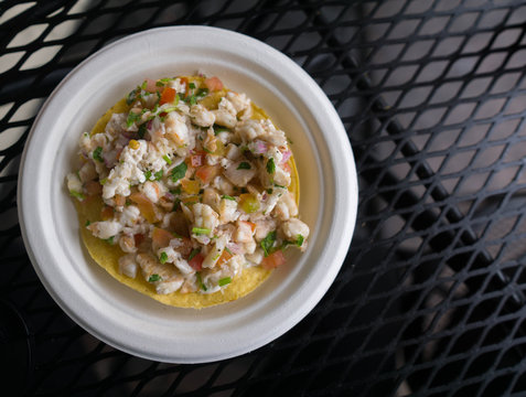 baja mexico refreshing shrimp ceviche tostada on a white plate