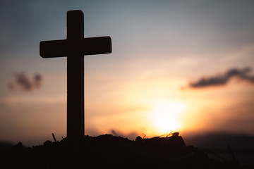 Religious concepts. Christian wooden cross on a background with dramatic lighting,  Jesus Christ cross, Easter, resurrection concept. Christianity, Religion copyspace background.