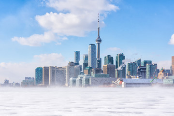 Toronto frozen lake Ontario. Early morning panoramic view of downtown with snow blizzard