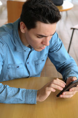 portrait of young man sitting on a sofa at home