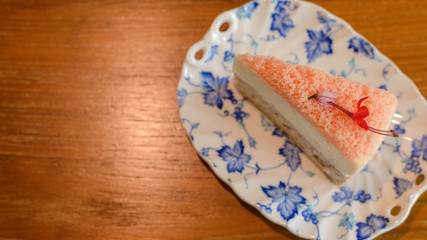 Top view of Piece of homemade taro cake in classic plate on table with copy space for text