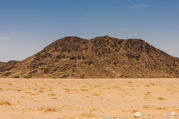 A lava outcrop in the desert of Saudi Arabia. Such outcrops are results of the volcanic eruptions happened millions years ago.