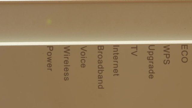 Modern router with green blinking LED lights, starts up, close up