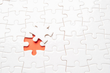 Fototapeta premium pieces of blank jigsaw puzzle for copy space, replacement words or text. Close up selective focus.