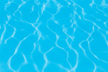 Blue pool water with sun reflections