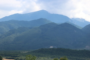 aerial view of Olympus mountains under cloudly sky, Greece