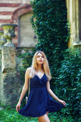 A young girl in the old town . Woman in summer dress