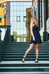 Obraz premium Young girl in summer dress on the streets of European cities