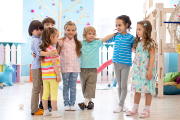 Group of happy kids at daycare or kindergarten - obrazy, fototapety, plakaty