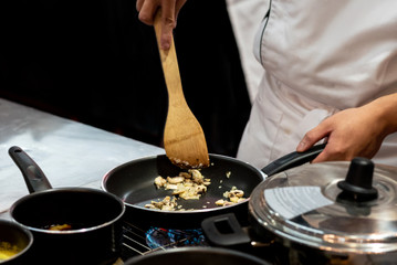 Chef preparing food in the kitchen, chef cooking, closeup