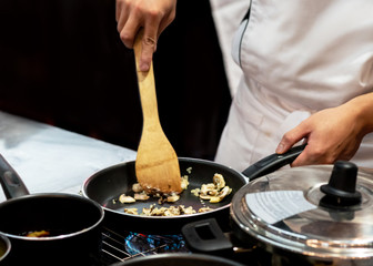 Chef preparing food in the kitchen, chef cooking, closeup