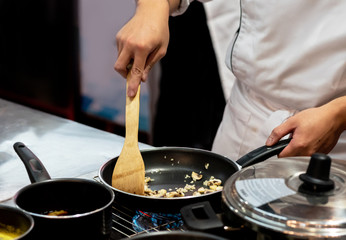 Chef preparing food in the kitchen, chef cooking, closeup