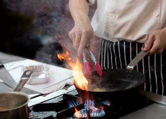 Chef preparing food in the kitchen, chef cooking, closeup