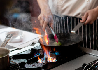 Chef preparing food in the kitchen, chef cooking, closeup