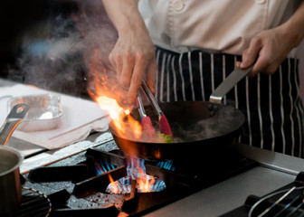 Chef preparing food in the kitchen, chef cooking, closeup