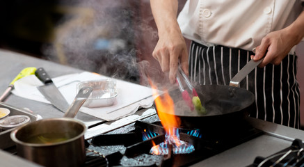 Chef preparing food in the kitchen, chef cooking, closeup