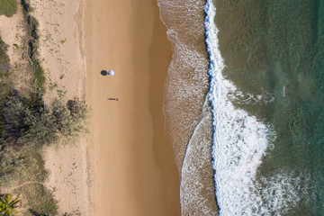 Beach aerial view of umbrellas, waves, blues ocean and relaxing vibes