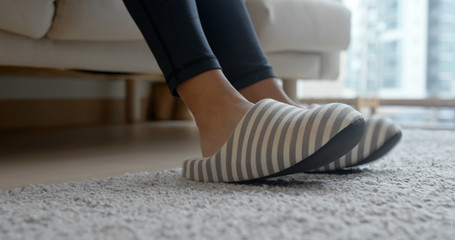 Woman wearing slipper at home - obrazy, fototapety, plakaty