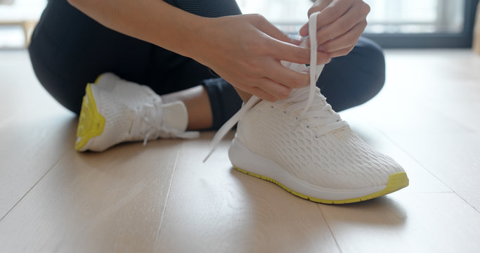 Woman Wearing Sport Shoes At Home