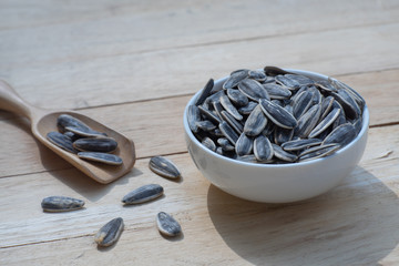 Sunflower seed, snack, in wooden bowl on wood table