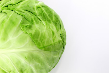 Young fresh cabbage white close-up on a white background. Green leaf. Fresh crop