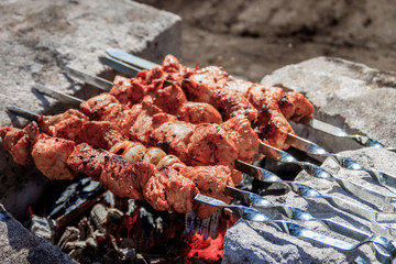 pork shish kebab on skewers. marinated meat. meat kebab. skewers on skewers. cooking on fire.