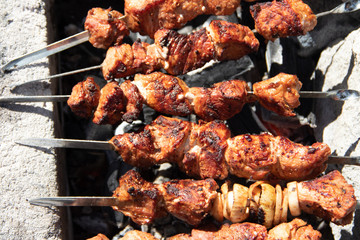 pork shish kebab on skewers. marinated meat. meat kebab. skewers on skewers. cooking on fire.