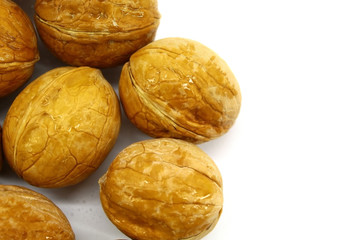 Large oval walnut on a white background, the product is crude, in a shell