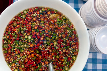 A hot chiillies fish sauce in the white bowl