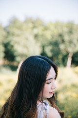 Naklejka premium Portrait of Young Asian woman girl smile in flower garden
