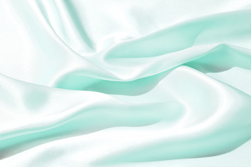 Obraz premium The texture of the satin fabric of green color for the background