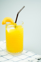 Freshly squeezed sweet orange juice and decoration with slice peach