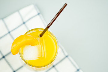 Freshly squeezed sweet orange juice and decoration with slice peach