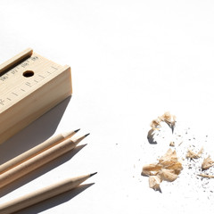 Pencil case and pencils are lying on the table in bright daylight. Natural unpainted wood. Eco-friendly materials