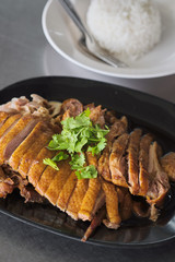 Duck breast on black plate with dumplings sauce .chinese style dish.