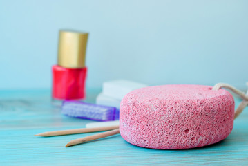 Pedicure accessories with nail polish on wooden background