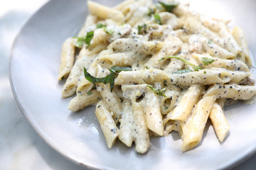 Penne pasta with white sauce and truffle , italian food