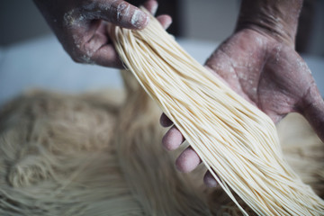 Making Handmade Noodles on wood background