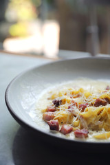 fettuccine carbonara , fettuccine pasta spaghetti with bacon ham and mushroon in white sauce italian food