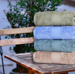 CLOSE UP OF STACKED SOFT AND COLOR COTTON BATH TOWEL. COTTON TOWEL ISOLATED.