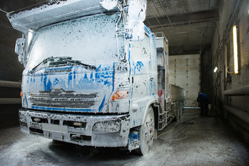 The element of the cab of the blue truck in the lather during washing.