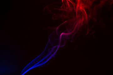 Fototapeta premium Colorful smoke close-up on a black background