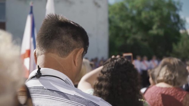 A man photographs graduates in school or college