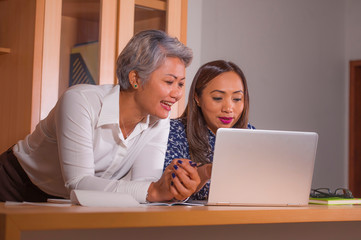 business partners women collaborating and coworking happy and successful at office laptop computer desk in job female colleagues cooperation and success