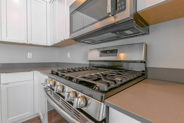 Close up of the cooktop and oven of a range inside a modern kitchen