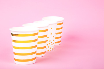 Paper cups on pink background. 