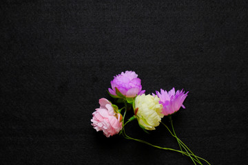 artificial flowers on black background